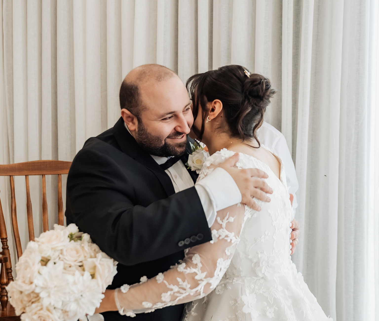 st george & st shenouda coptic church wedding - carmina & bill 29 Bride and groom share a tender wedding embrace during an elegant indoor reception.