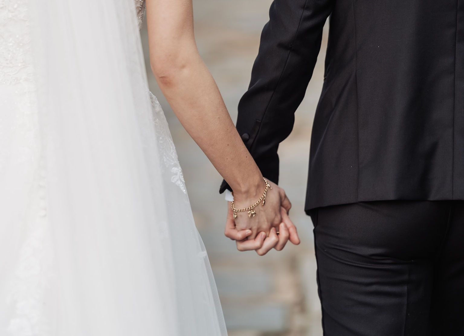 the manor wedding - crystal & mackenzie 82 Wedding couple holding hands, bride in white gown and groom in black suit.