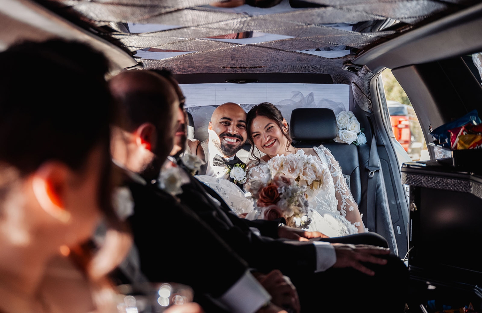 st george & st shenouda coptic church wedding - carmina & bill 54 Happy newlyweds riding in a limousine after their wedding ceremony.