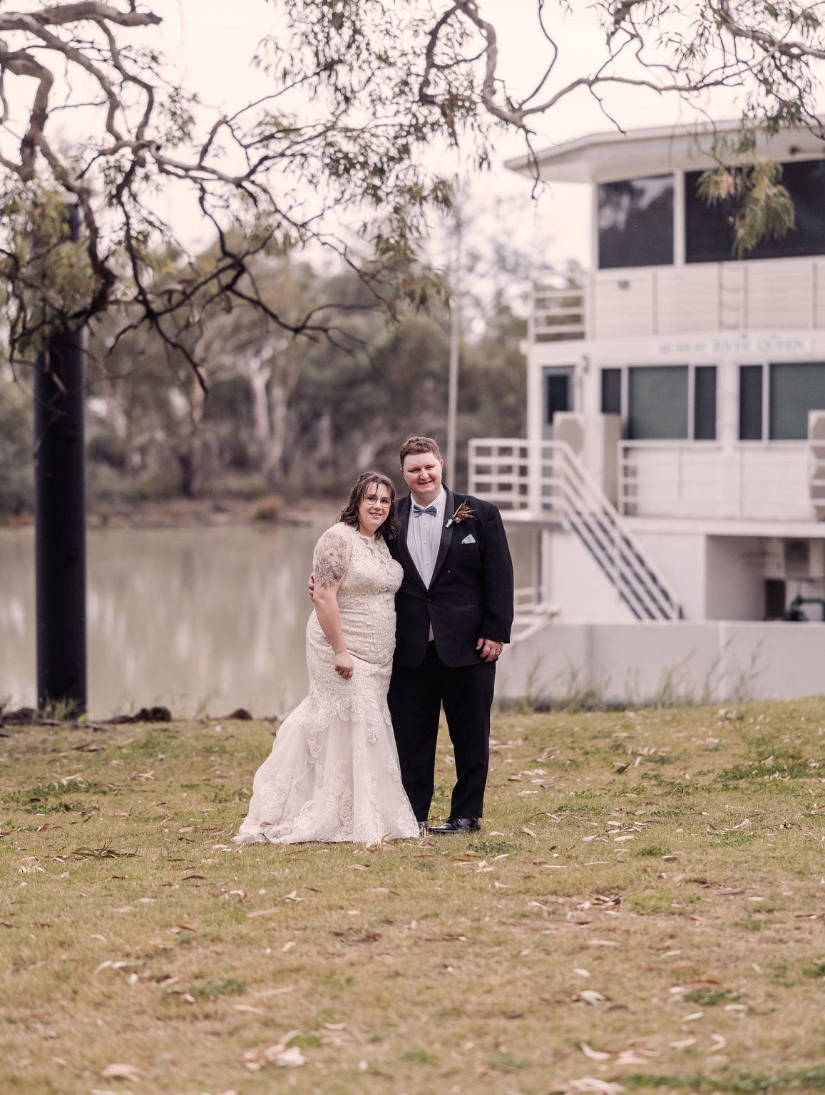 loxton's st peter's church wedding - madeline & brayden 72 Wedding couple portrait on riverbank beside docked riverboat.