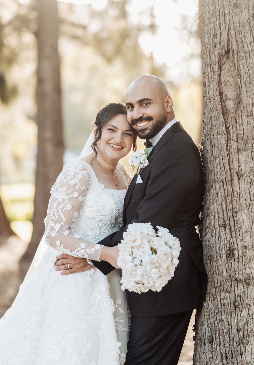st george & st shenouda coptic church wedding - carmina & bill 58 Newlywed bride and groom portrait by tree in romantic woodland wedding setting.