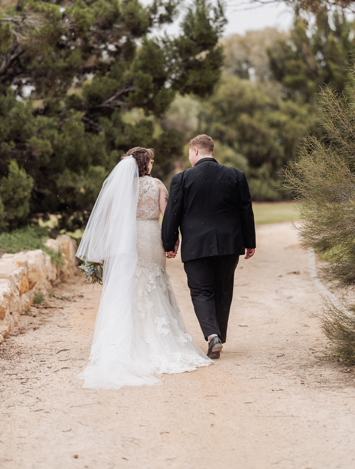 loxton's st peter's church wedding - madeline & brayden 47 Bride and groom walking hand in hand on romantic outdoor wedding path.