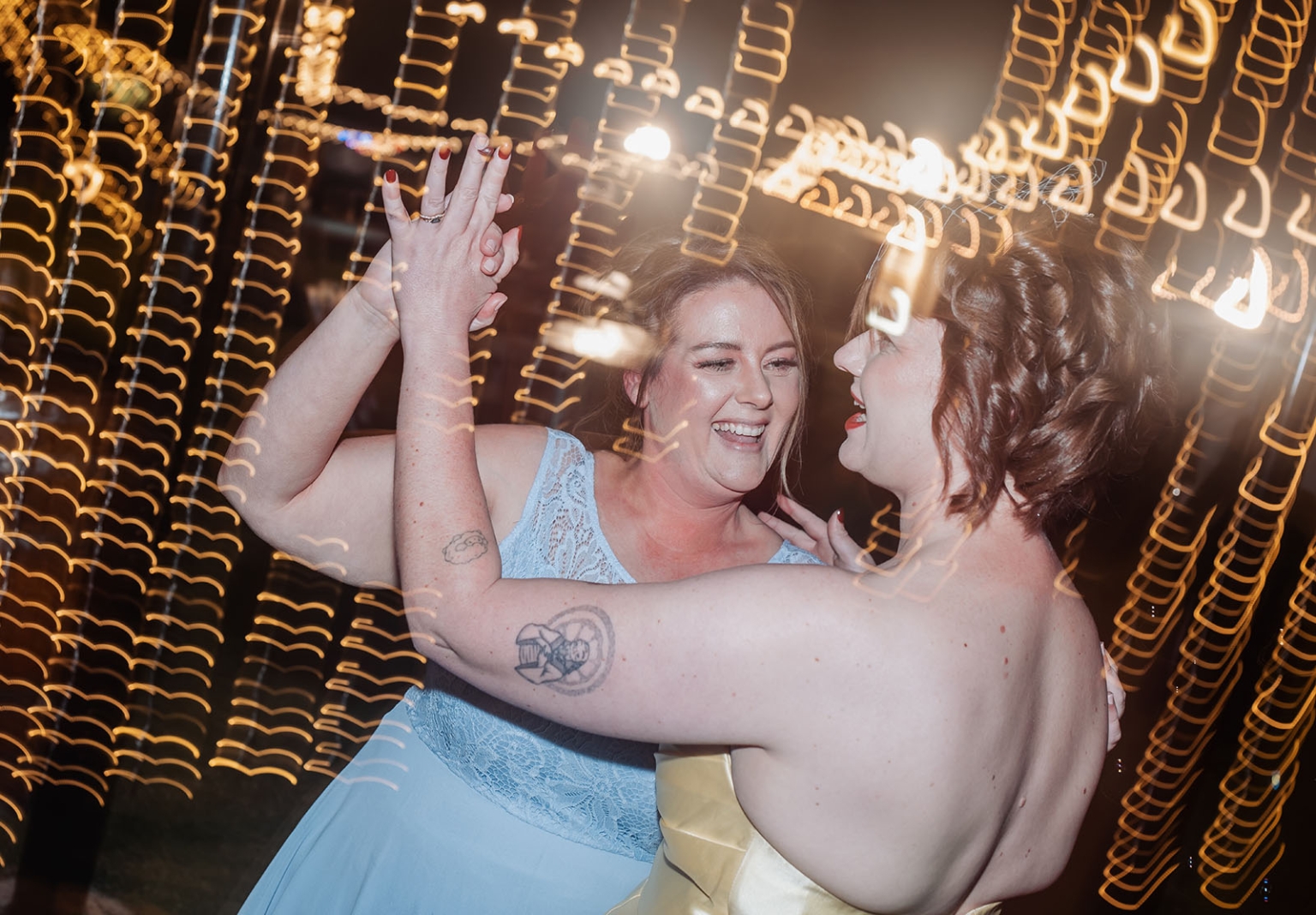 tiny house on the prairie wedding - lauren & bek 65 Joyful wedding guests dancing under golden lights at nighttime reception.