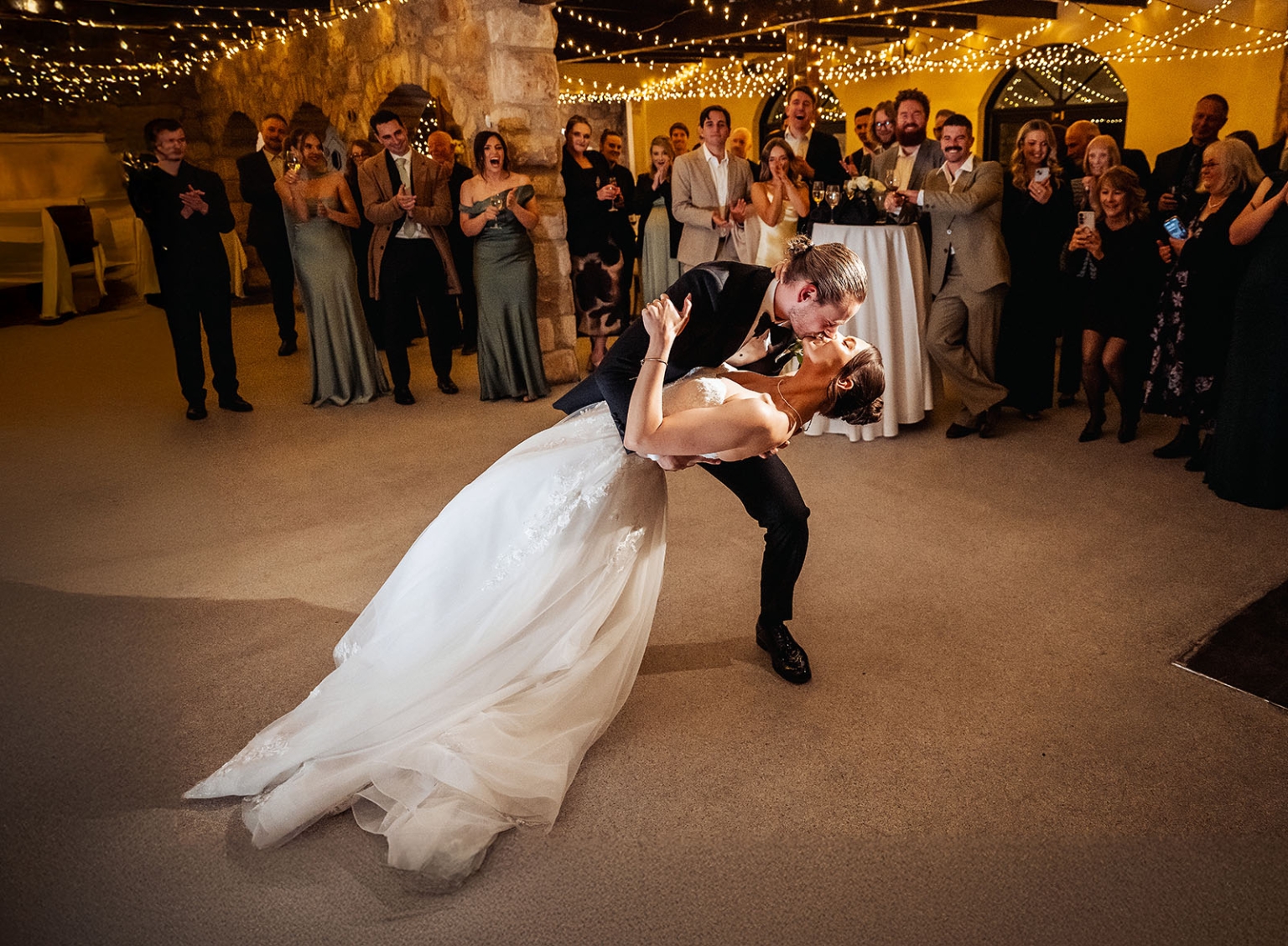 the manor wedding - crystal & mackenzie 95 Bride and groom dip kiss during romantic wedding first dance reception.