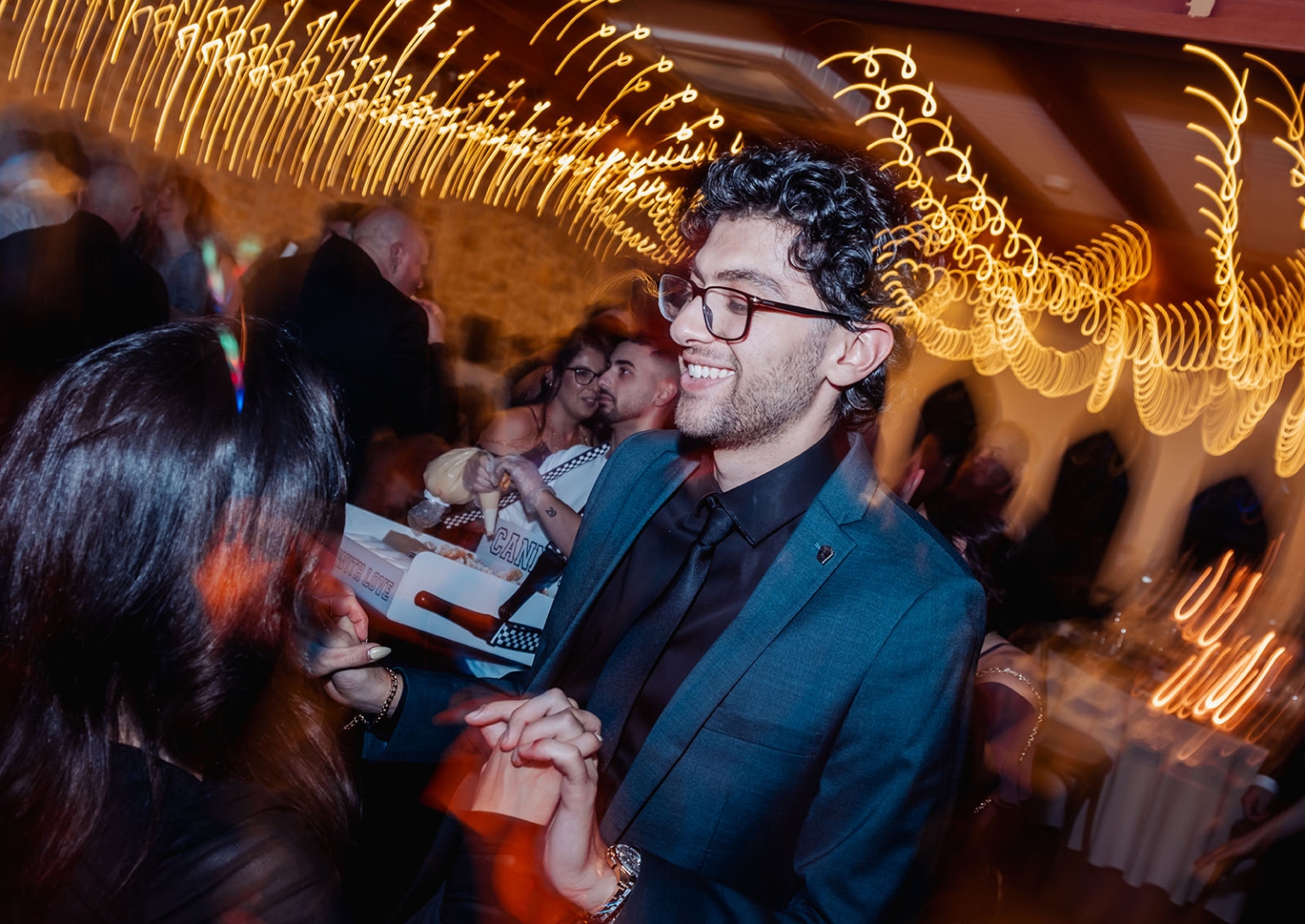 photo scavenger hunt qr code – why interactive challenges beat printable games every time 1 Wedding reception dance floor with joyful guests and golden light trails.