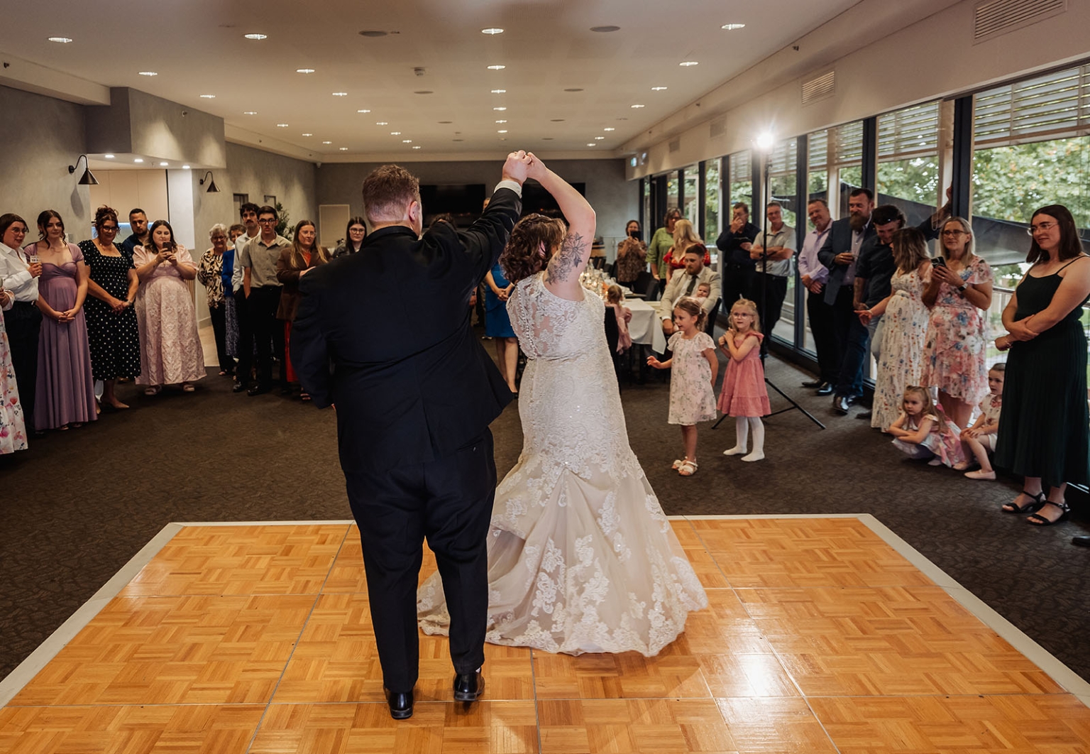loxton's st peter's church wedding - madeline & brayden 61 Bride and groom twirl during wedding first dance at elegant reception.