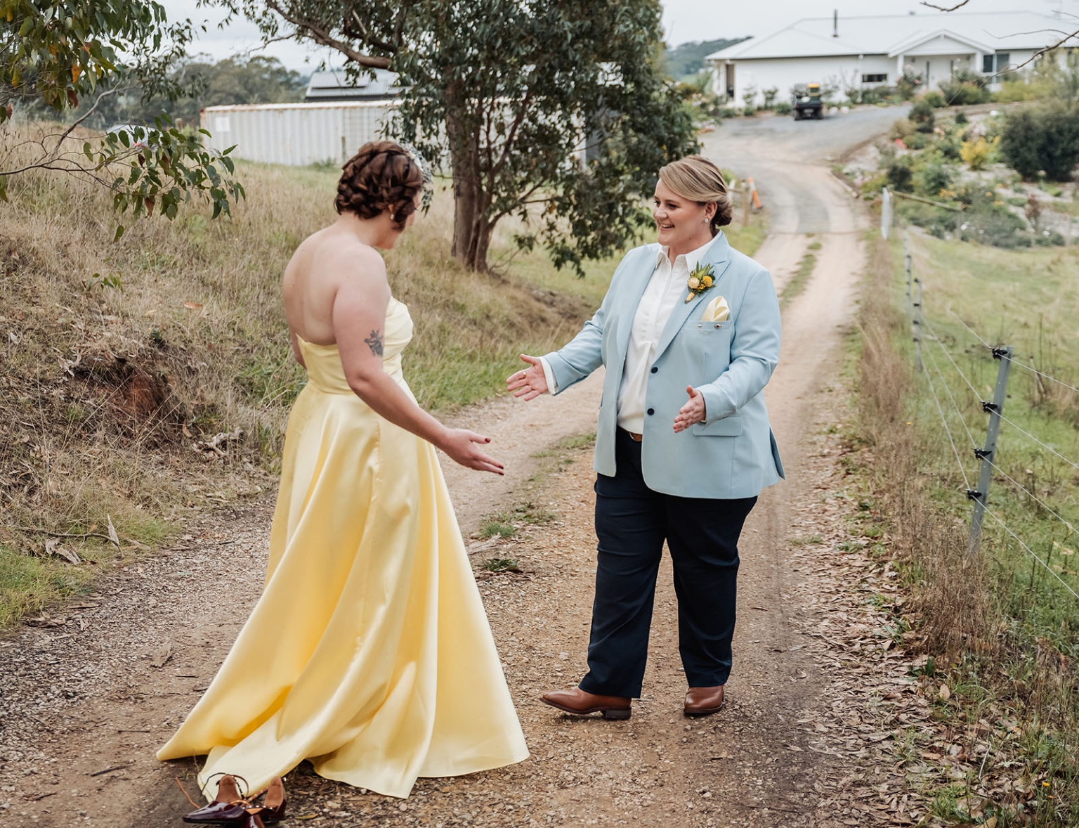 tiny house on the prairie wedding - lauren & bek 14 Countryside wedding first look with yellow gown and blue suit.