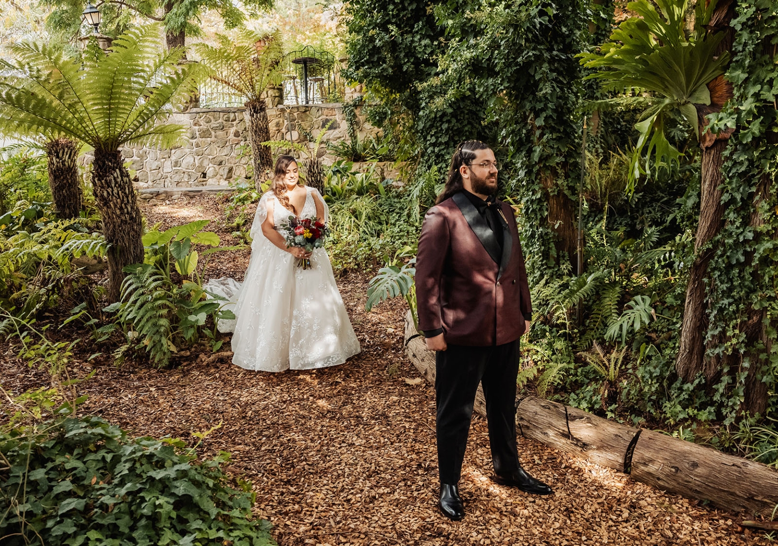 basket range wedding at the manor - leah & wes 28 Romantic garden wedding first look with burgundy groom and bride holding bouquet.