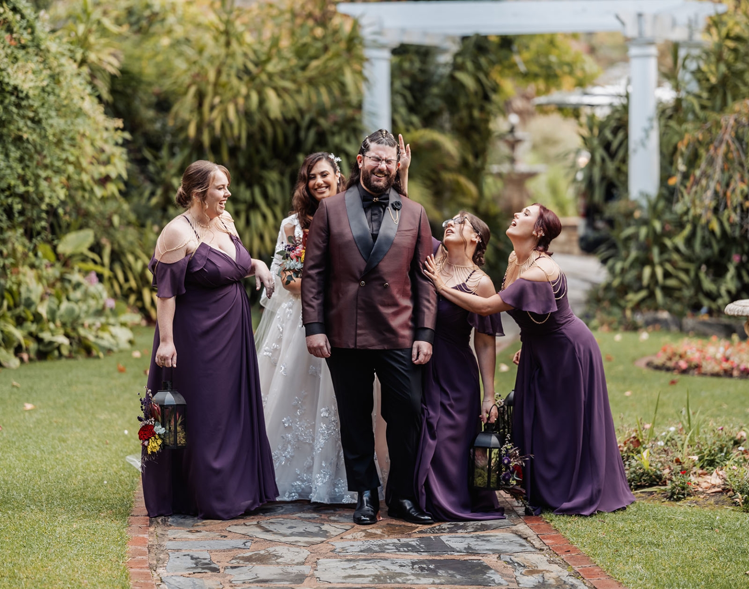 basket range wedding at the manor - leah & wes 30 Joyful wedding party garden portrait with bride, groom, and bridesmaids.
