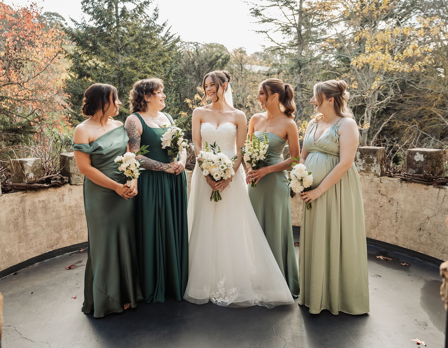 the manor wedding - crystal & mackenzie 29 Bride with bridesmaids in green dresses at outdoor autumn wedding.