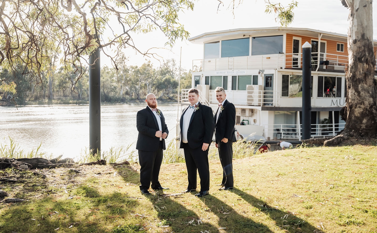 loxton's st peter's church wedding - madeline & brayden 13 Wedding party groomsmen in black suits by Murray River Queen riverboat.