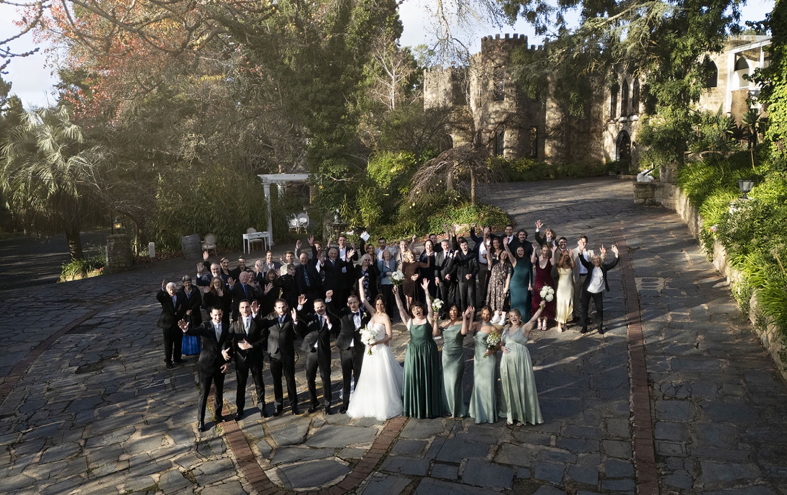 the manor wedding - crystal & mackenzie 61 Wedding party celebrates in historic stone castle courtyard garden.