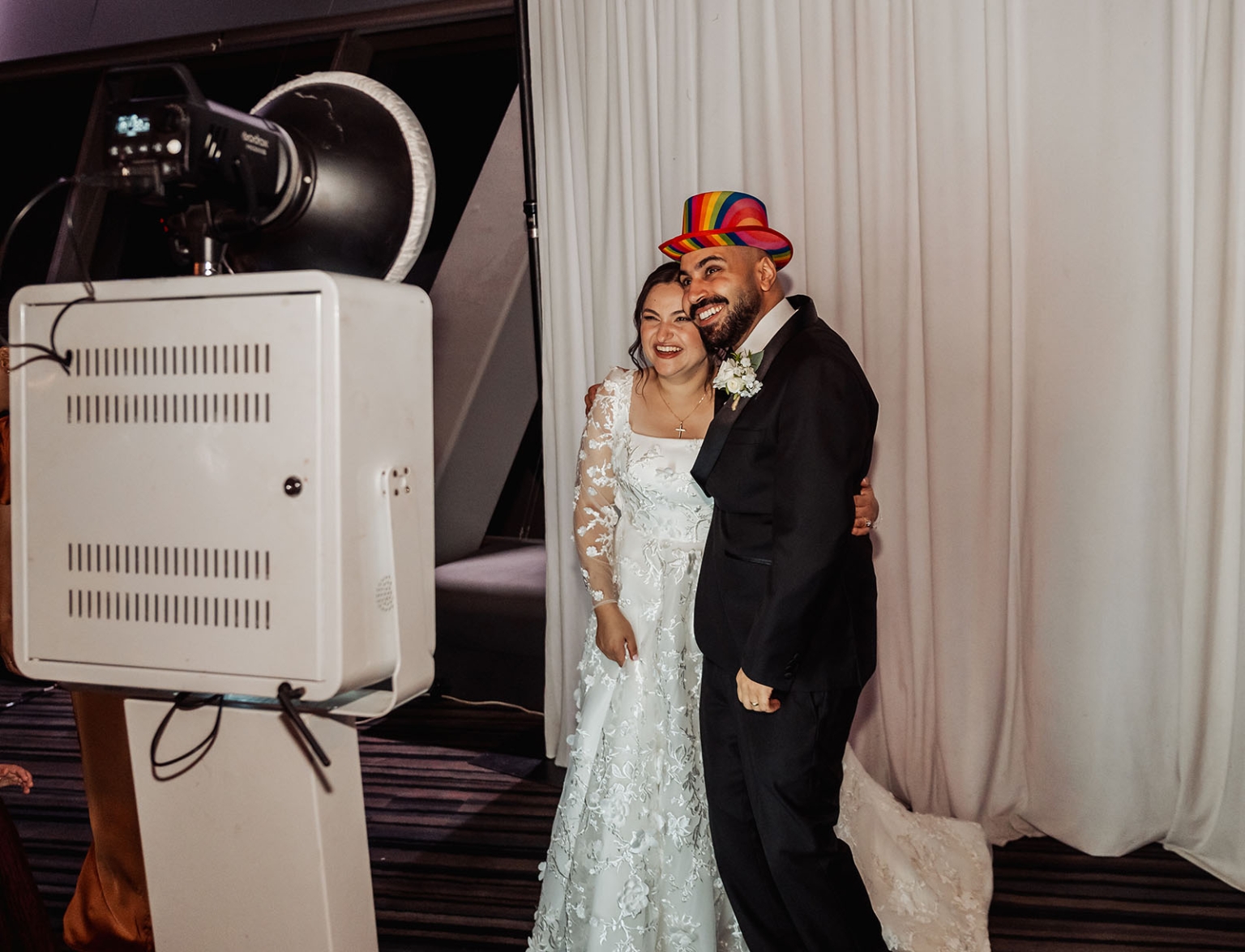 st george & st shenouda coptic church wedding - carmina & bill 88 Bride and groom posing at wedding photo booth with rainbow top hat.