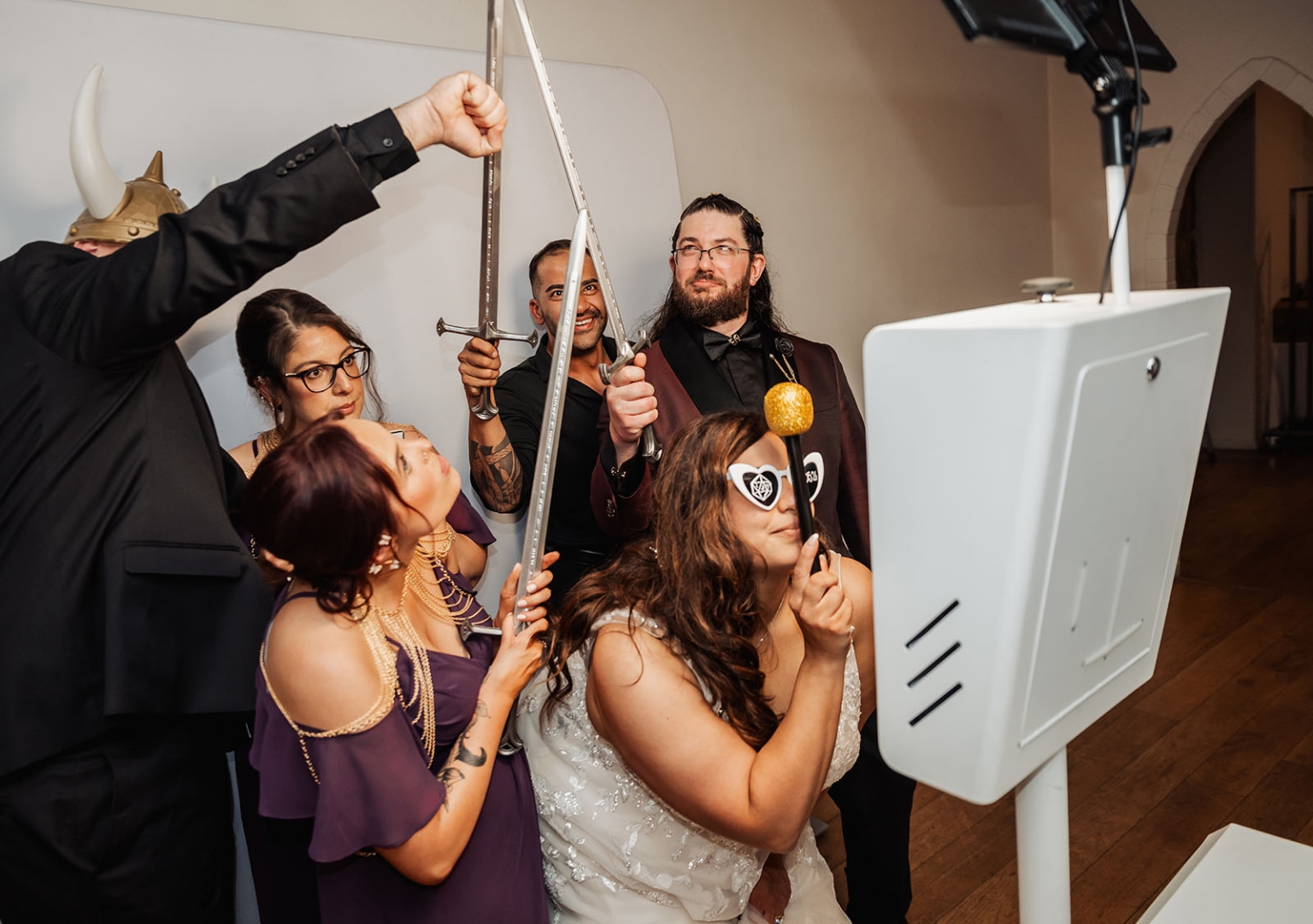 basket range wedding at the manor - leah & wes 73 Wedding guests pose at photo booth with fantasy props and toy swords.