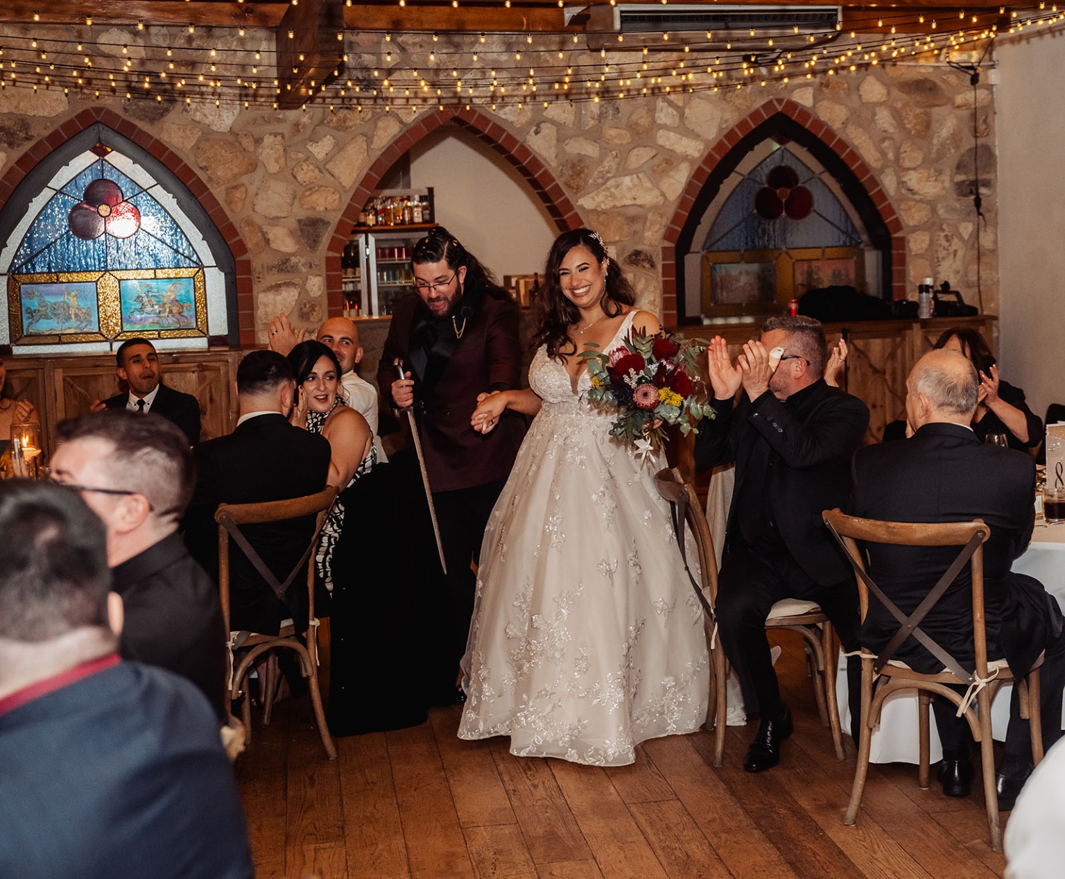 basket range wedding at the manor - leah & wes 71 Bride and groom enter rustic wedding reception as guests applaud.