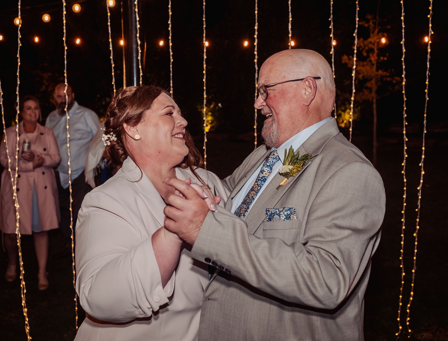 tiny house on the prairie wedding - lauren & bek 67 Joyful wedding reception dance under romantic string lights.