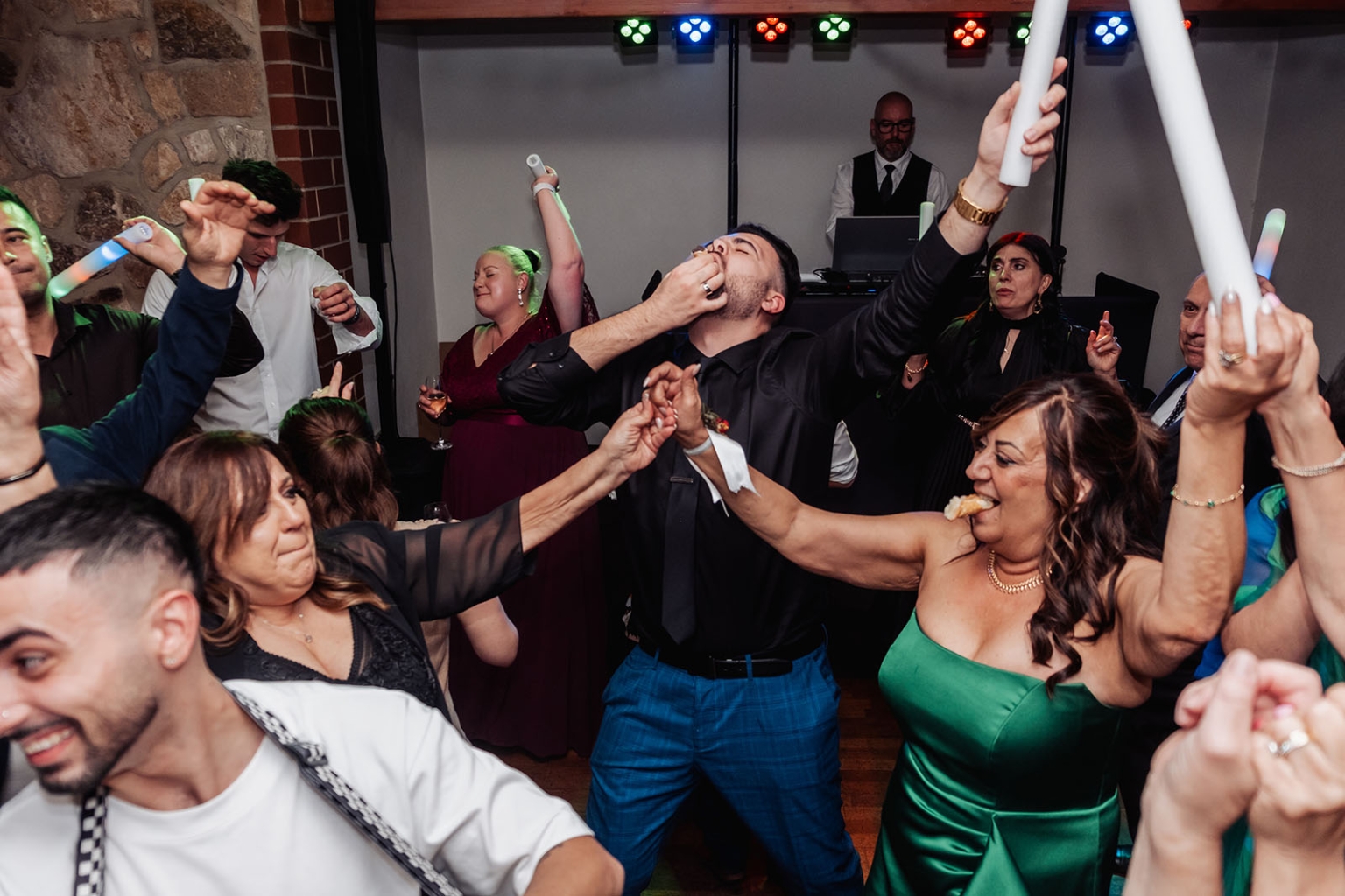 photo scavenger hunt qr code – why interactive challenges beat printable games every time 3 Wedding reception dance floor with guests celebrating, DJ, and colorful party lights.