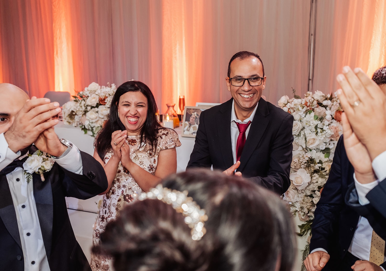 st george & st shenouda coptic church wedding - carmina & bill 90 Wedding reception guests laughing and applauding during a joyful celebration.