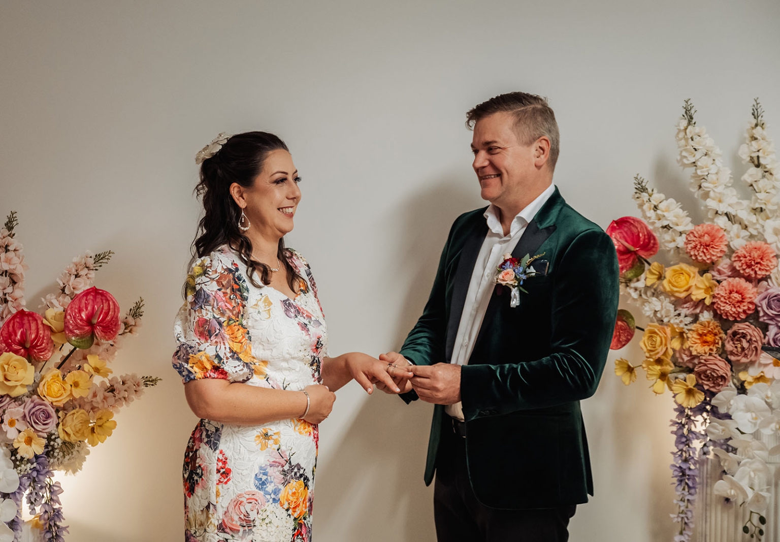 sa marriage office wedding – melissa & kyran 202 Couple exchanging wedding rings during a romantic floral ceremony.