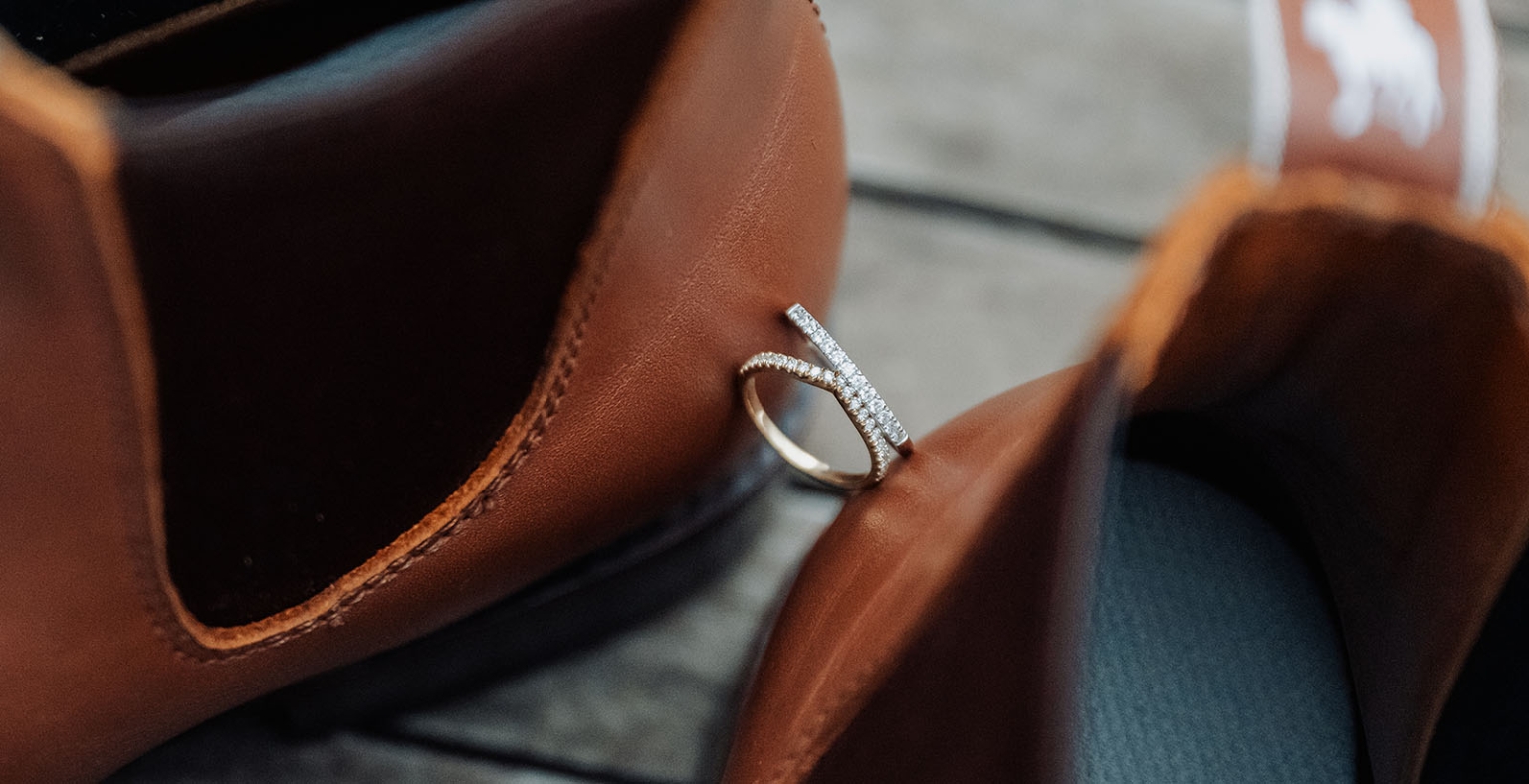 tiny house on the prairie wedding - lauren & bek 7 Wedding rings nestled between polished brown leather dress shoes.