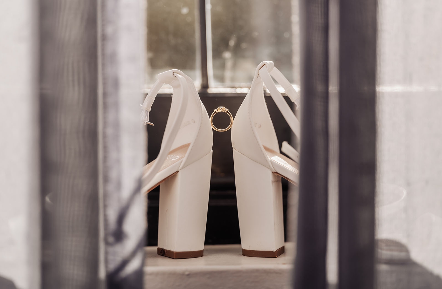 the manor wedding - crystal & mackenzie 16 White bridal heels and gold wedding ring on a windowsill.