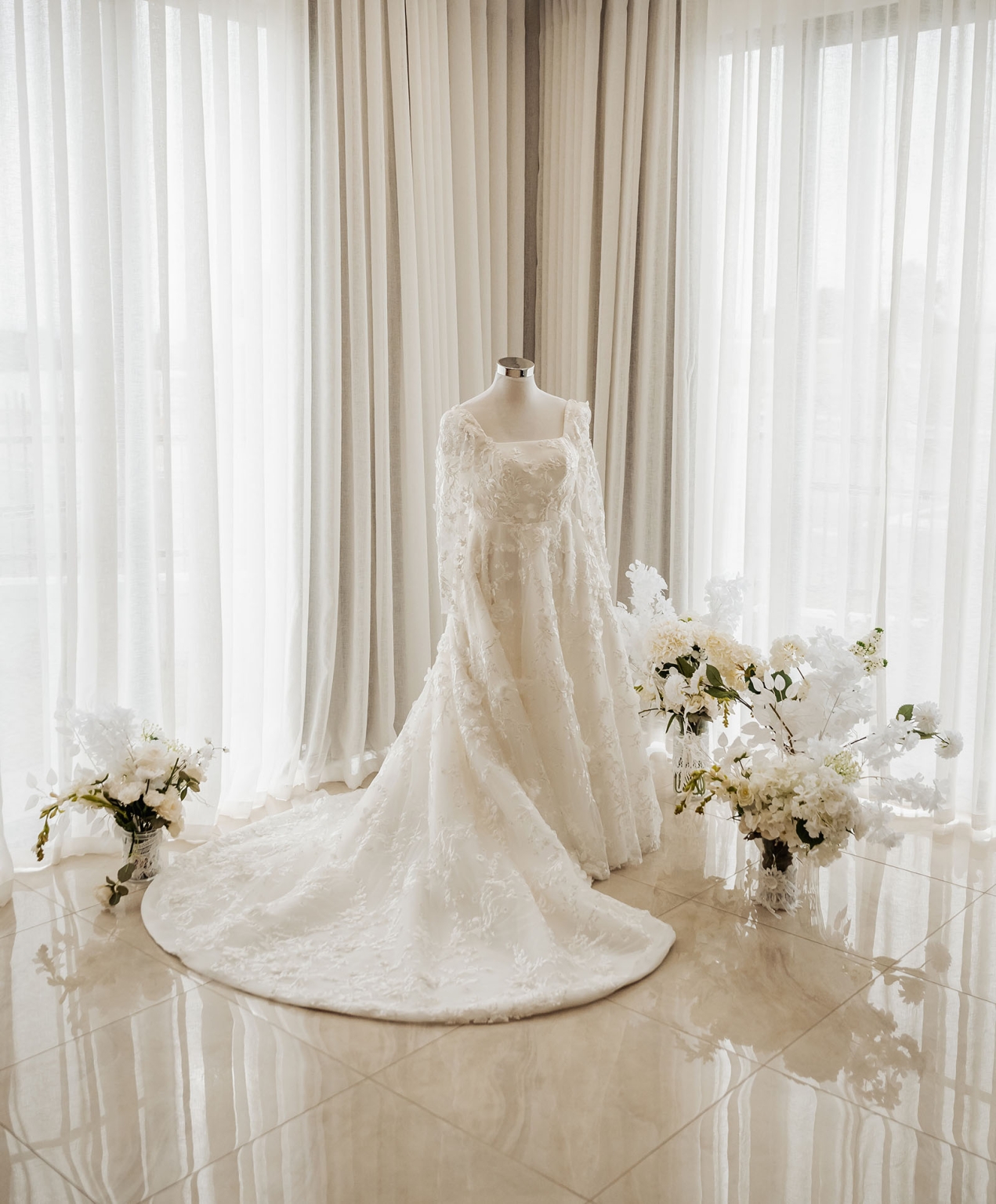 st george & st shenouda coptic church wedding - carmina & bill 21 Elegant white lace wedding gown with long train and floral bridal boutique display.