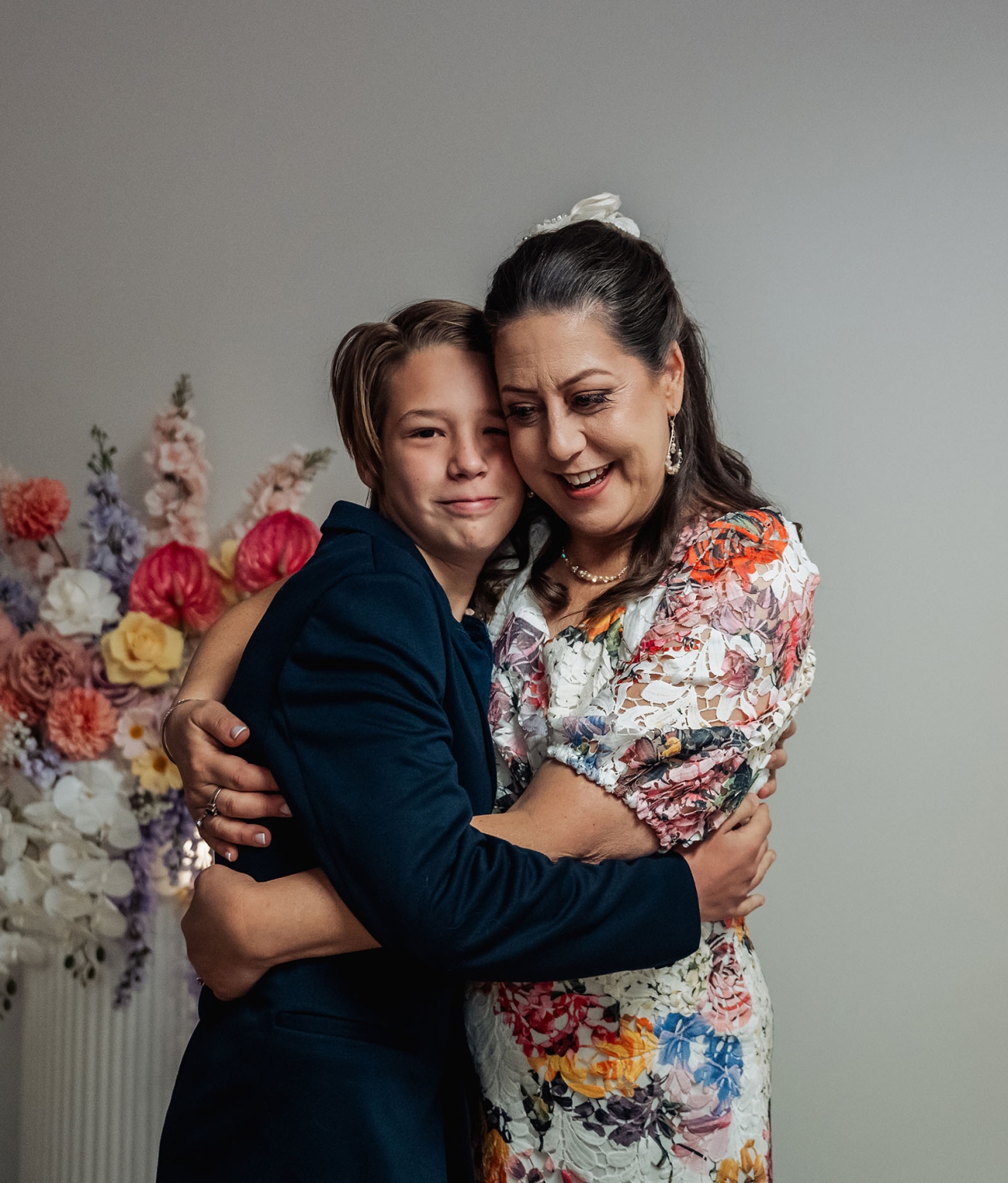 sa marriage office wedding – melissa & kyran 205 Woman and boy embracing in formal family portrait with wedding flowers.