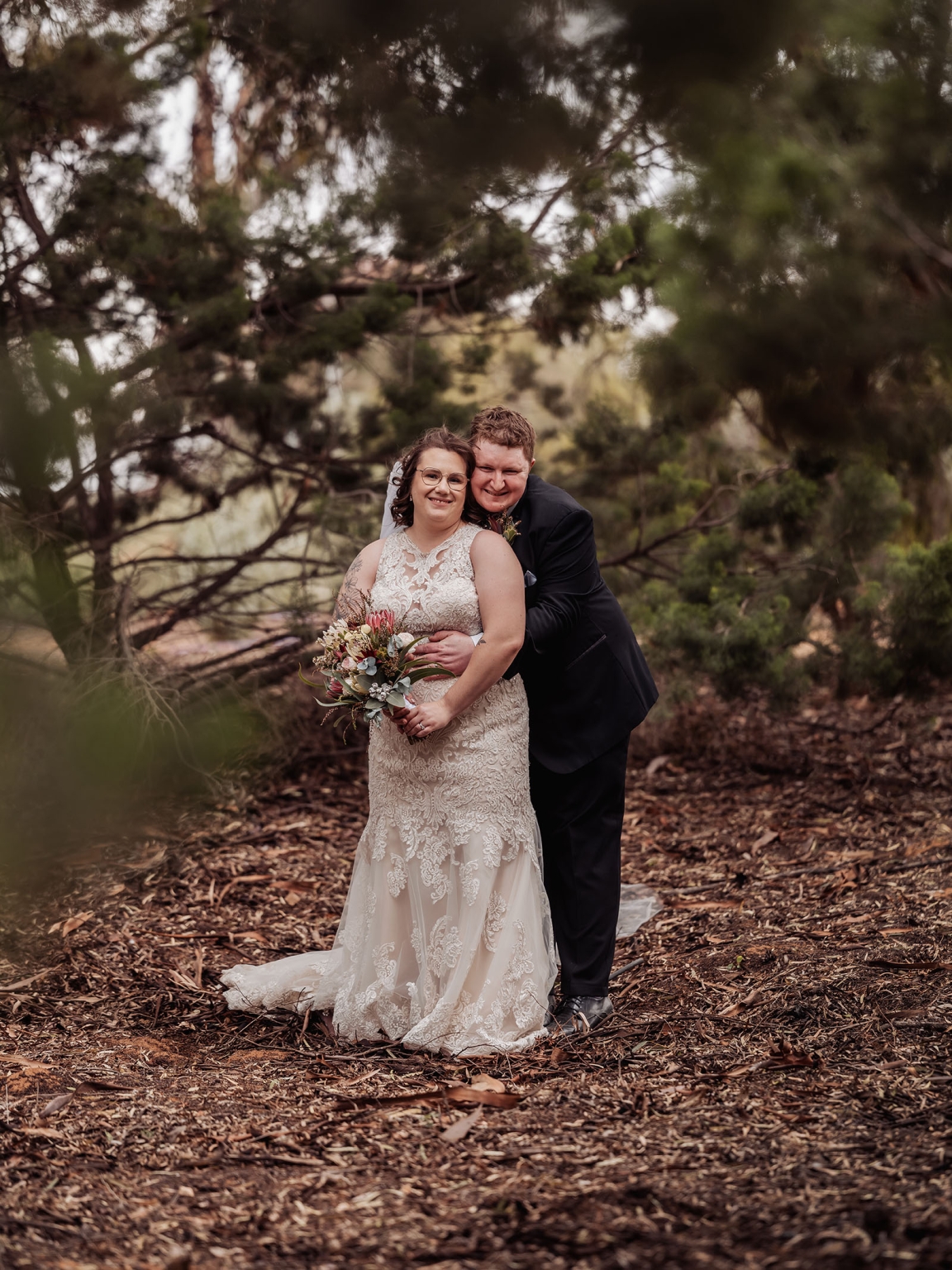 loxton's st peter's church wedding - madeline & brayden 53 Woodland wedding couple portrait with bride and groom embracing in romantic forest setting.