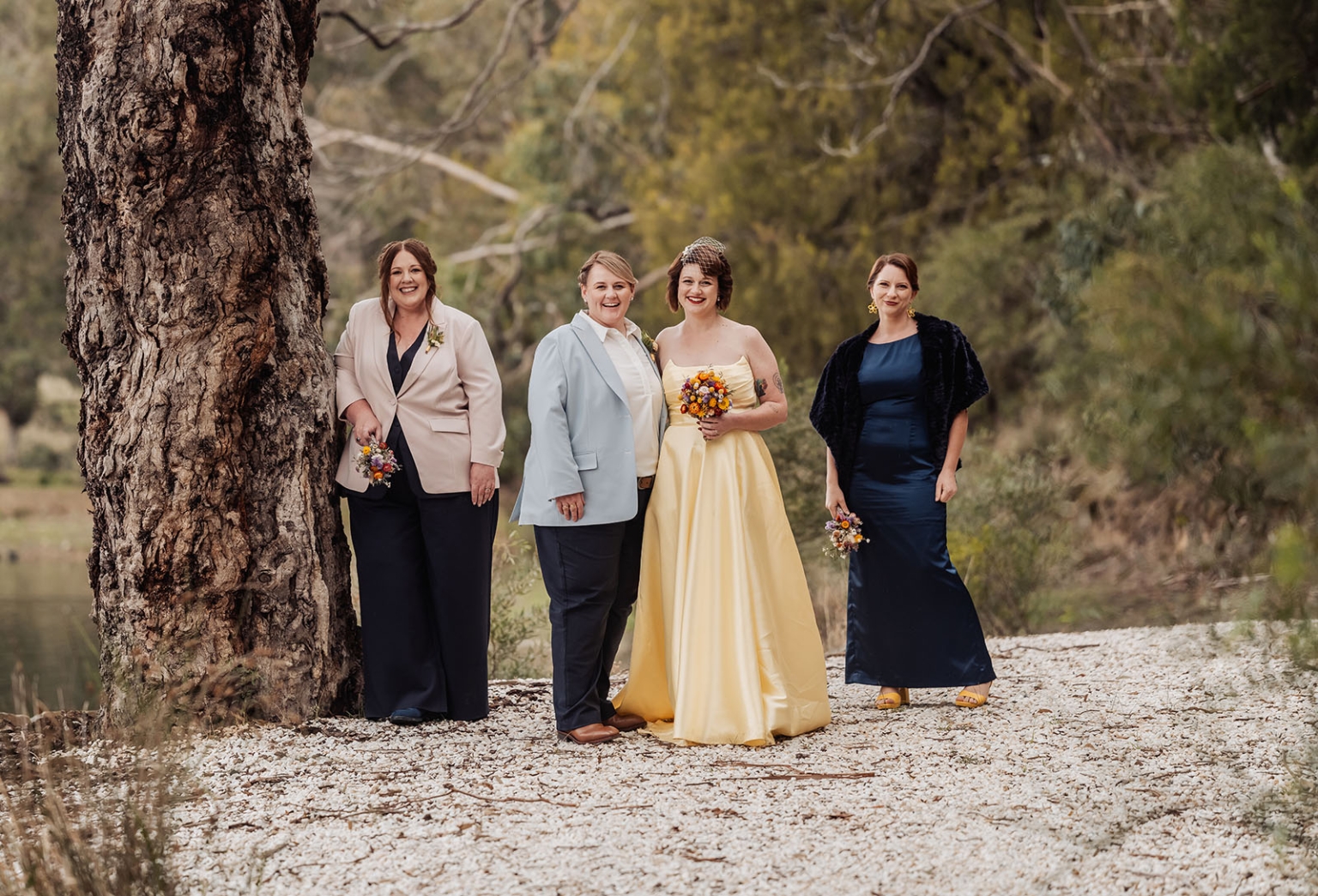 tiny house on the prairie wedding - lauren & bek 45 Woodland wedding group portrait with couple, attendants, colorful bouquets by rustic tree.