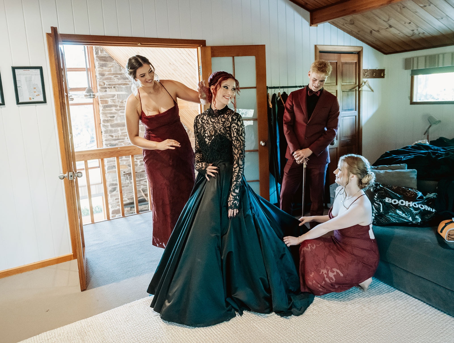 kuitpo hall wedding - courtney & jarrod 206 Bride in black wedding gown with burgundy attendants in rustic dressing room.