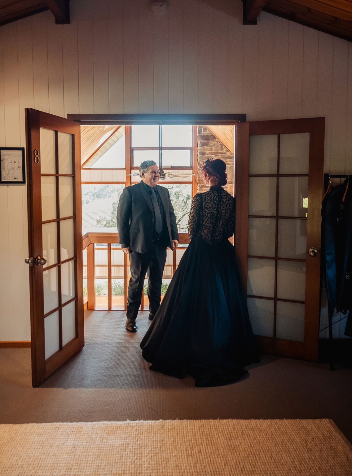kuitpo hall wedding - courtney & jarrod 209 Bride in black gown shares first look with groom at rustic lodge wedding.