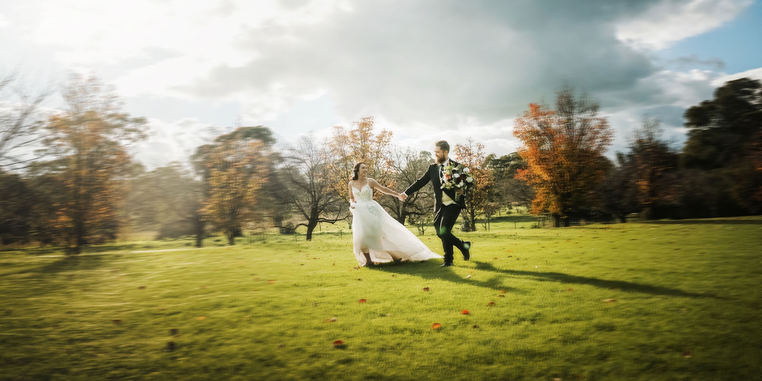 wedding at al-ru farm – teresa & thomas 14 Bride and groom running across a sunlit autumn wedding lawn.
