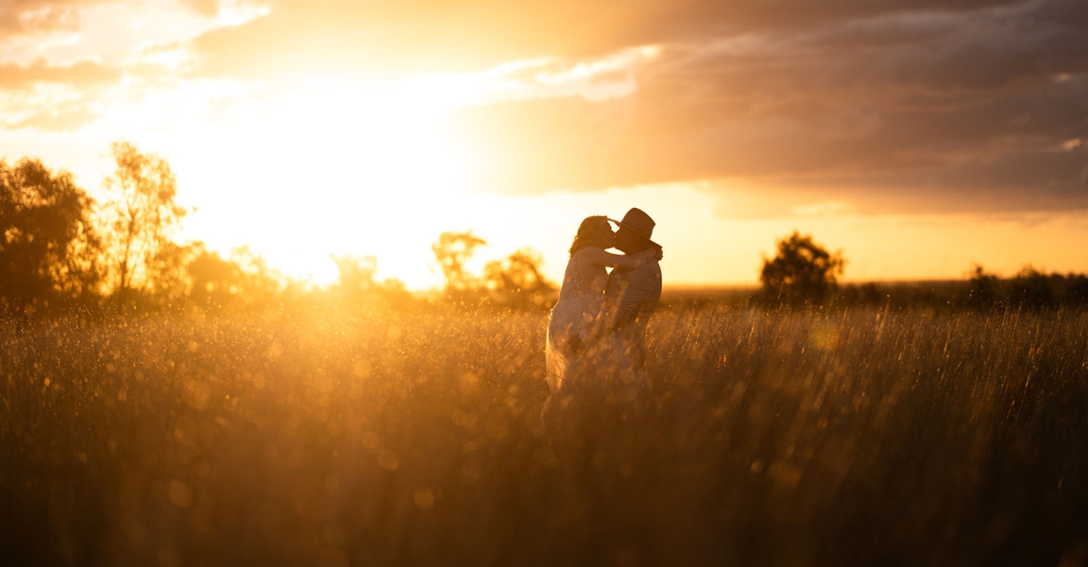 capella wedding photography – caitlin & adam’s farm wedding 169 Caitlin and Adam embracing in a grassy field at sunset during their Capella farm wedding