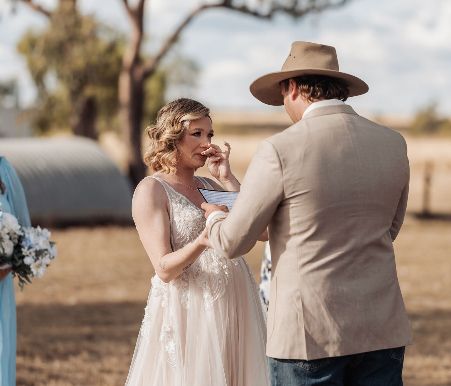 capella wedding photography – caitlin & adam’s farm wedding 144 Bride wiping away tears as she holds hands with the groom during their outdoor farm wedding vows in Capella