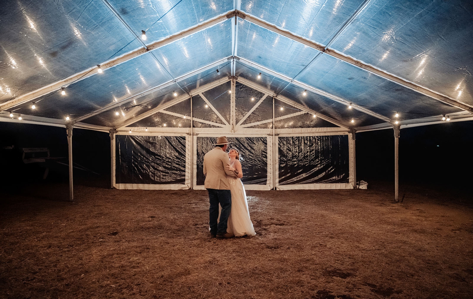 capella wedding photography – caitlin & adam’s farm wedding 175 Caitlin and Adam dancing beneath string lights in a clear-roofed marquee at their Capella farm wedding