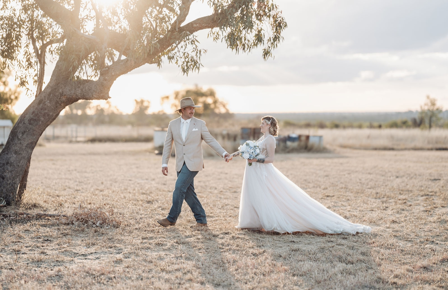 capella wedding photography – caitlin & adam’s farm wedding 166 Caitlin and Adam walking hand in hand beneath a gum tree at their Capella farm wedding