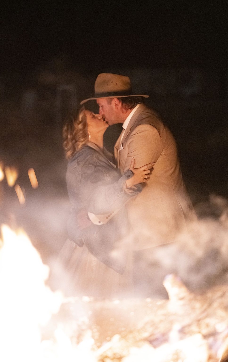 capella wedding photography – caitlin & adam’s farm wedding 189 Caitlin and Adam kissing beside a fire at their Capella farm wedding