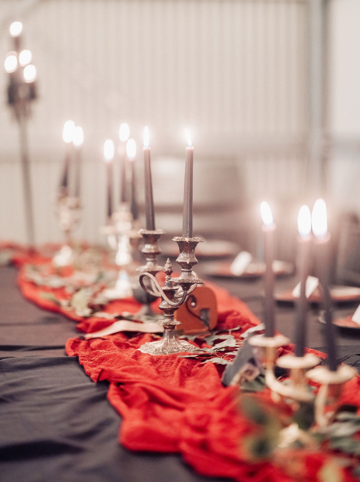 kuitpo hall wedding - courtney & jarrod 256 Elegant candlelit table with red runner and silver candlesticks for romantic wedding decor.