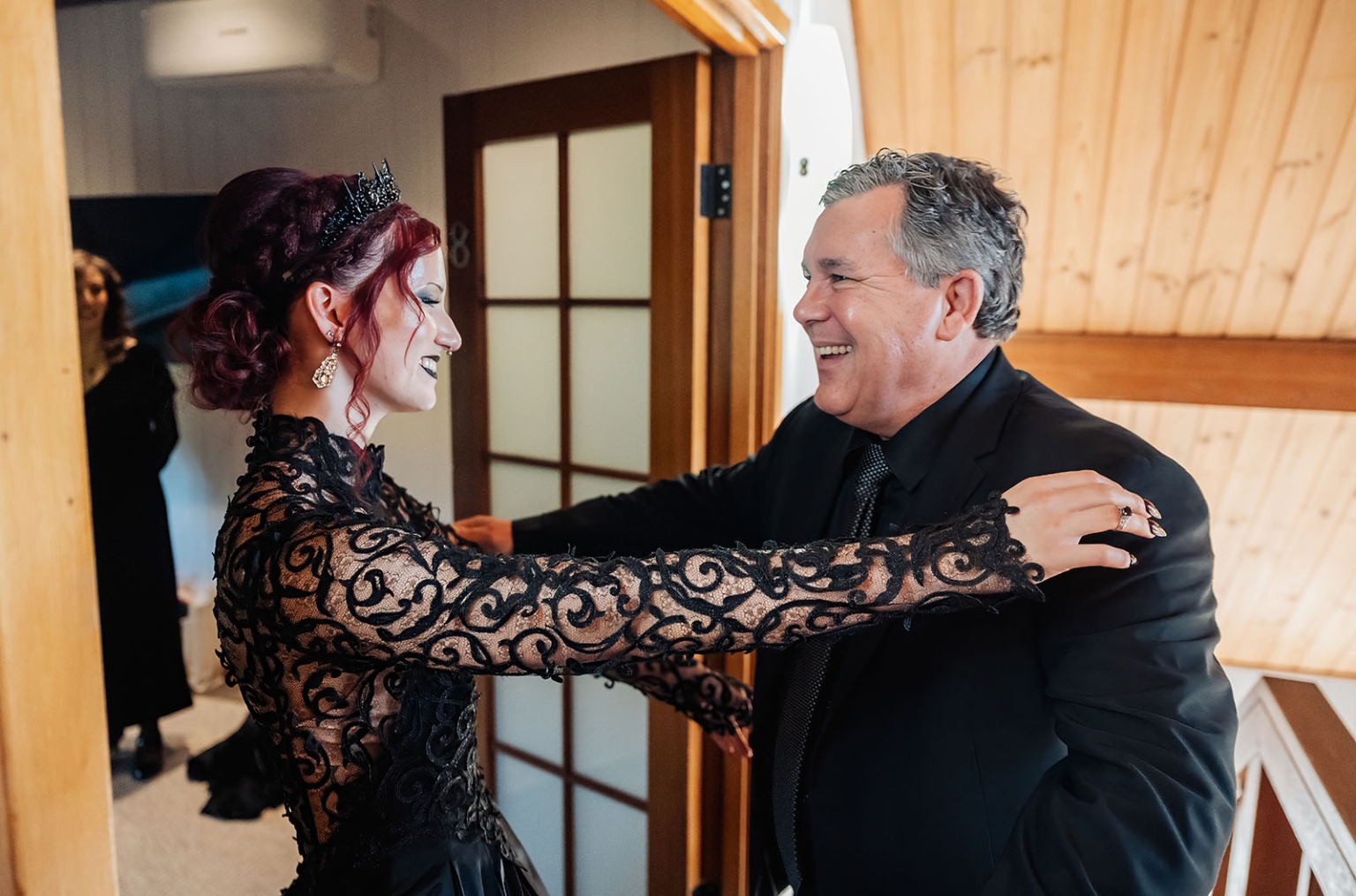 kuitpo hall wedding - courtney & jarrod 208 Elegant gothic woman greeting smiling man at formal indoor celebration.