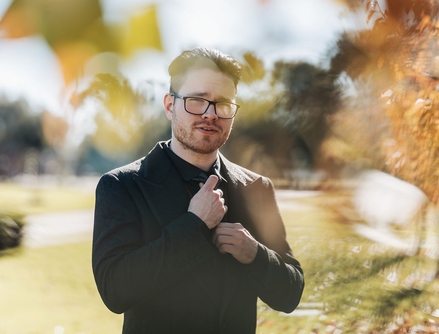 kuitpo hall wedding - courtney & jarrod 200 Formal mens outdoor portrait in black suit with glasses and golden garden light.