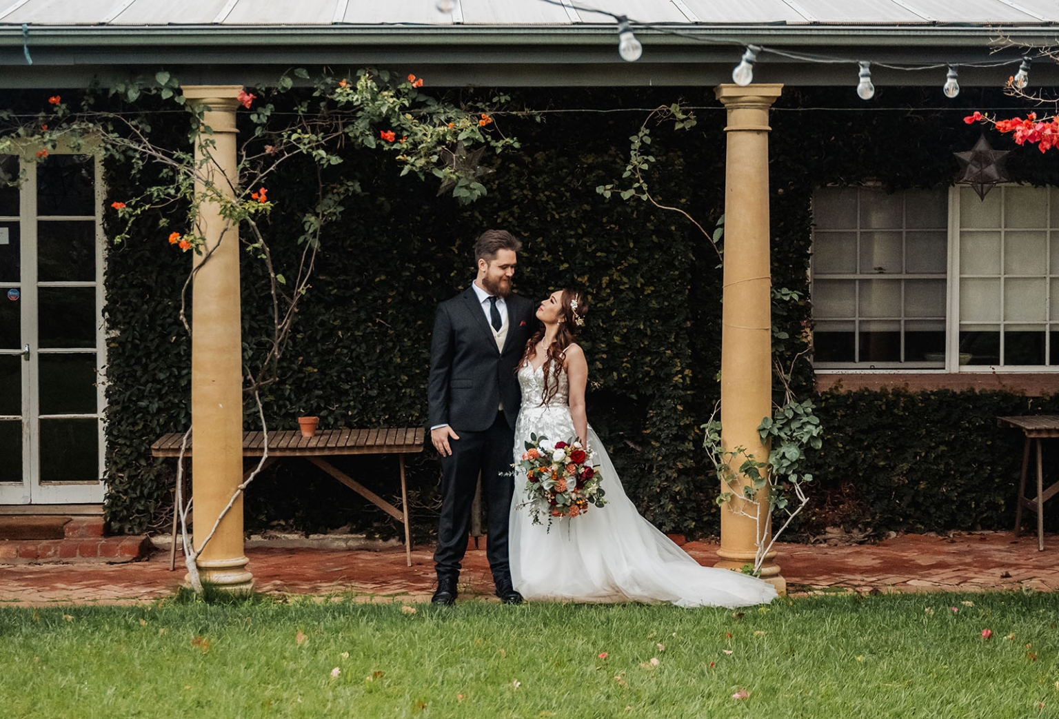 wedding at al-ru farm – teresa & thomas 34 Bride and groom at romantic garden wedding venue with ivy-covered veranda.