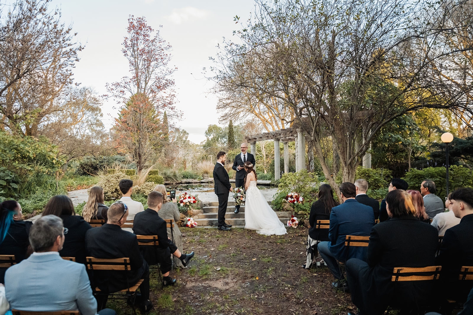 wedding at al-ru farm – teresa & thomas 23 Outdoor garden wedding ceremony with bride, groom, officiant, and guests.