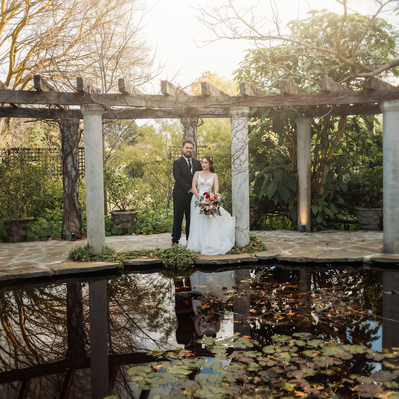 wedding at al-ru farm – teresa & thomas 15 Bride and groom wedding portrait under garden pergola by reflective pond.