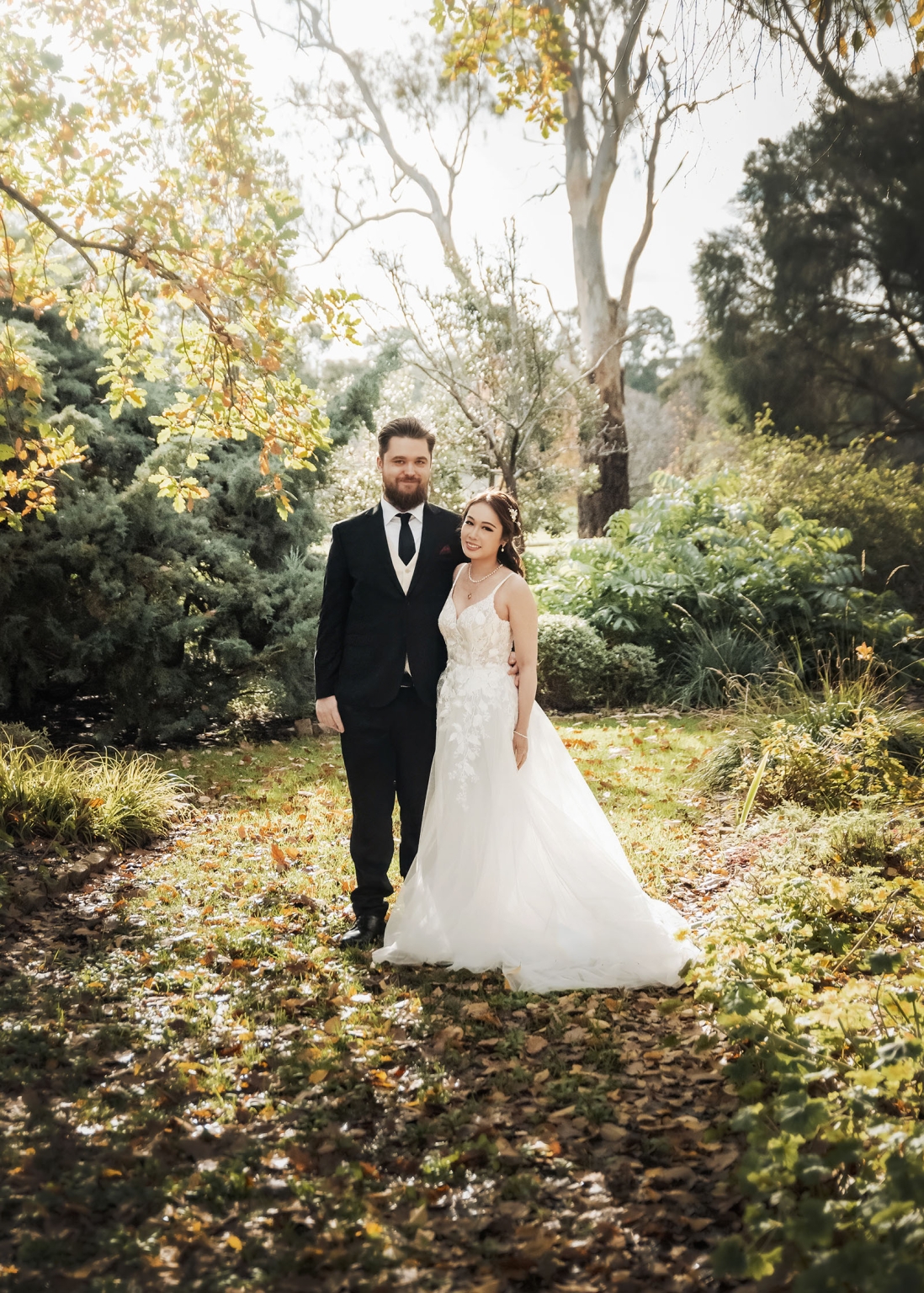 wedding at al-ru farm – teresa & thomas 4 Newlywed couple in a romantic garden wedding portrait with golden sunlight.