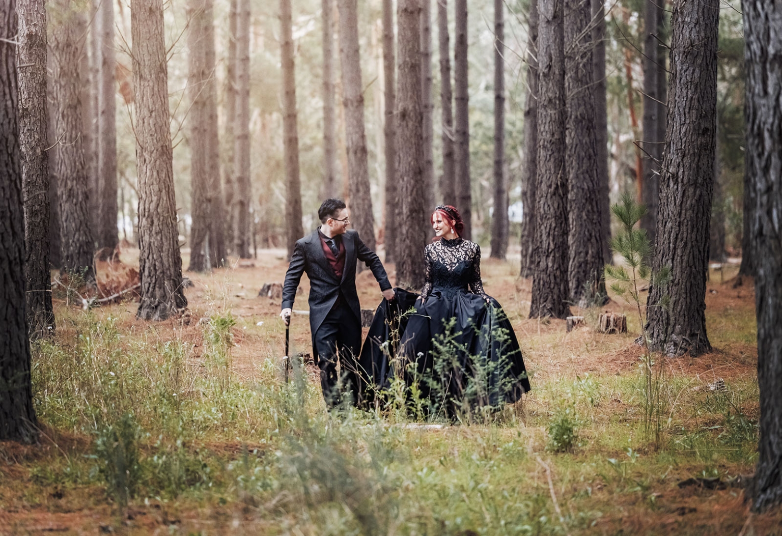 kuitpo hall wedding - courtney & jarrod 244 Gothic couple in formal attire walking through a romantic pine forest.