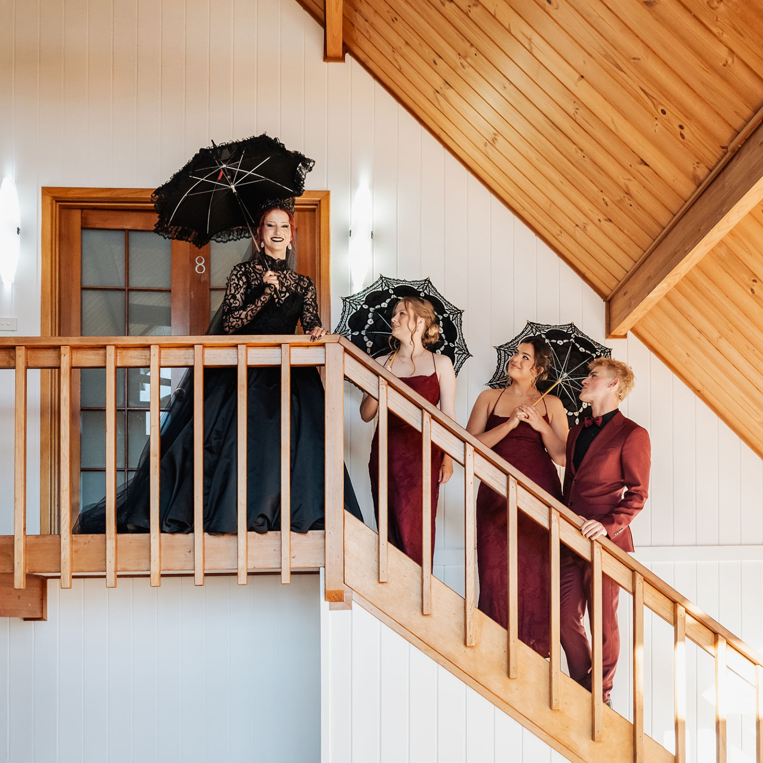 kuitpo hall wedding - courtney & jarrod 211 Gothic formal wedding party with black parasols posing on wooden staircase.