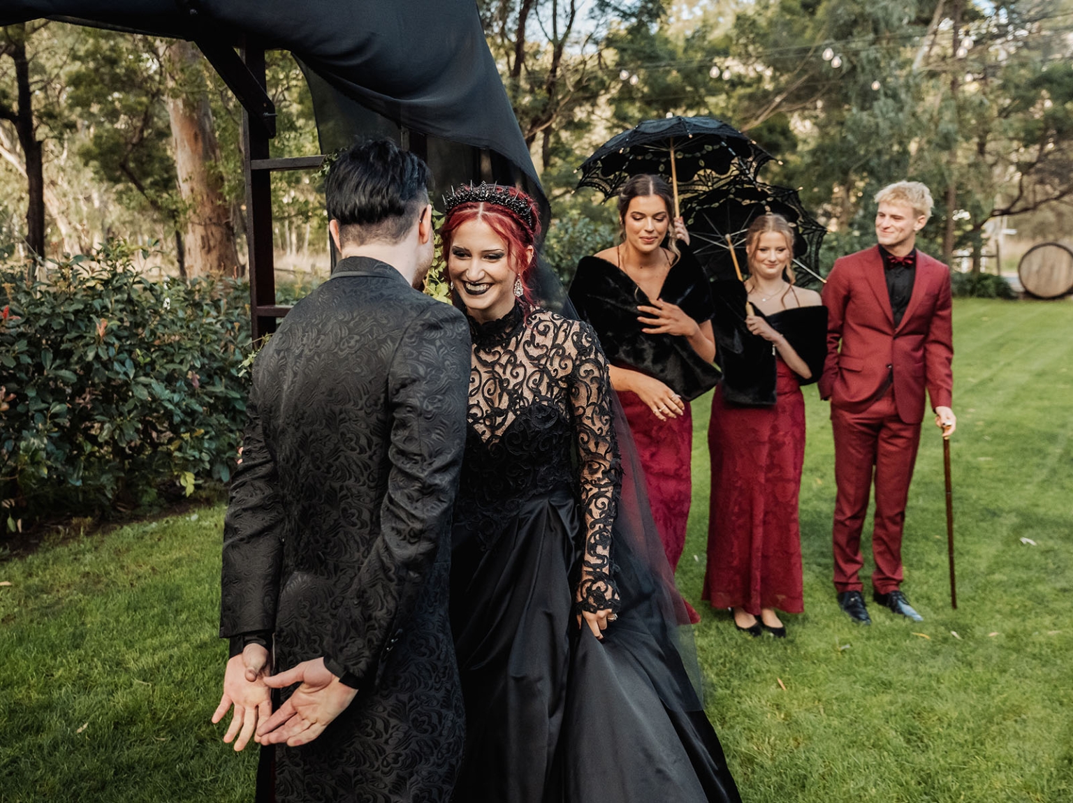 kuitpo hall wedding - courtney & jarrod 224 Gothic garden wedding ceremony with black bridal gown, burgundy party, and lace parasols.