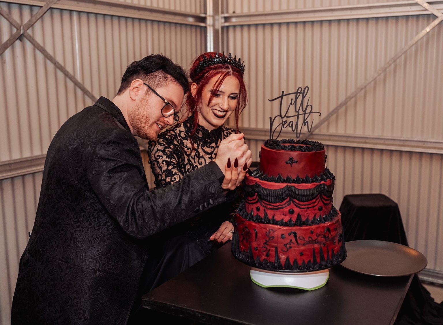 kuitpo hall wedding - courtney & jarrod 266 Gothic wedding couple cutting a red and black till death cake.