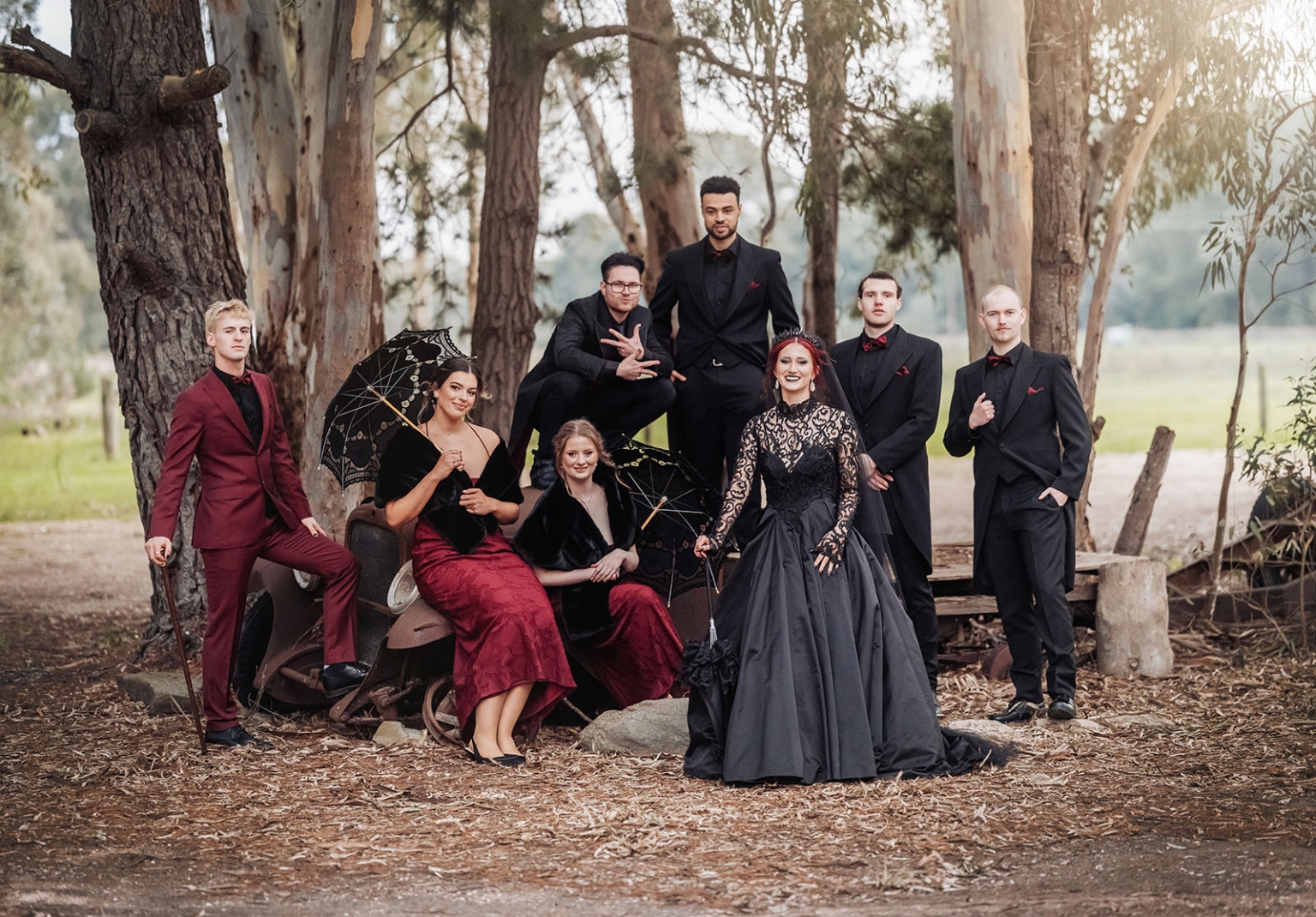 kuitpo hall wedding - courtney & jarrod 237 Gothic wedding party portrait in forest with black gowns, burgundy suits, and lace parasols.