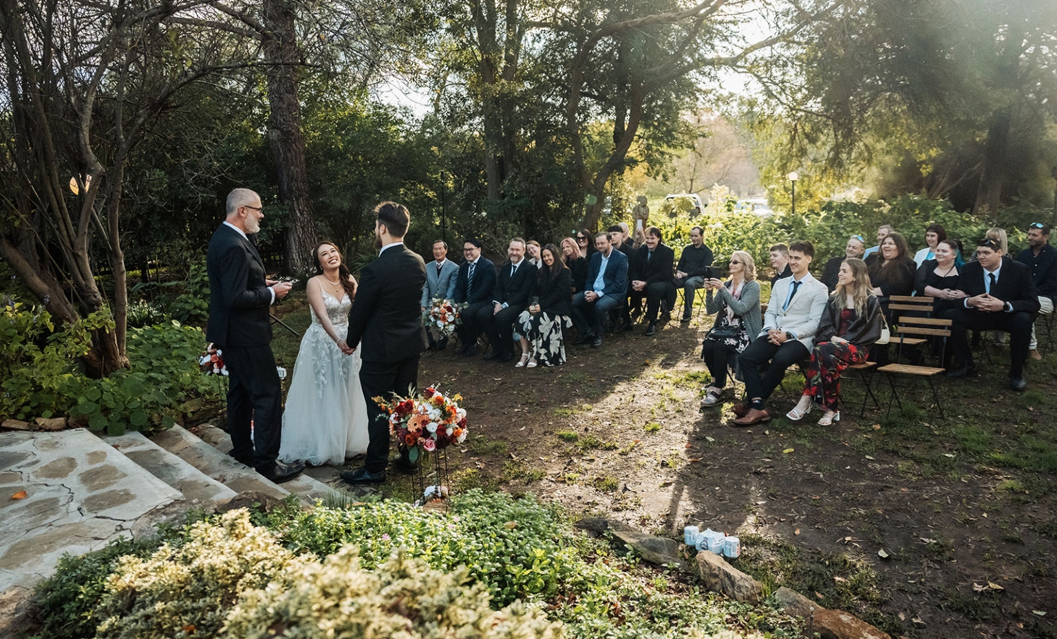 wedding at al-ru farm – teresa & thomas 24 Outdoor garden wedding ceremony with bride, groom, officiant, and guests.